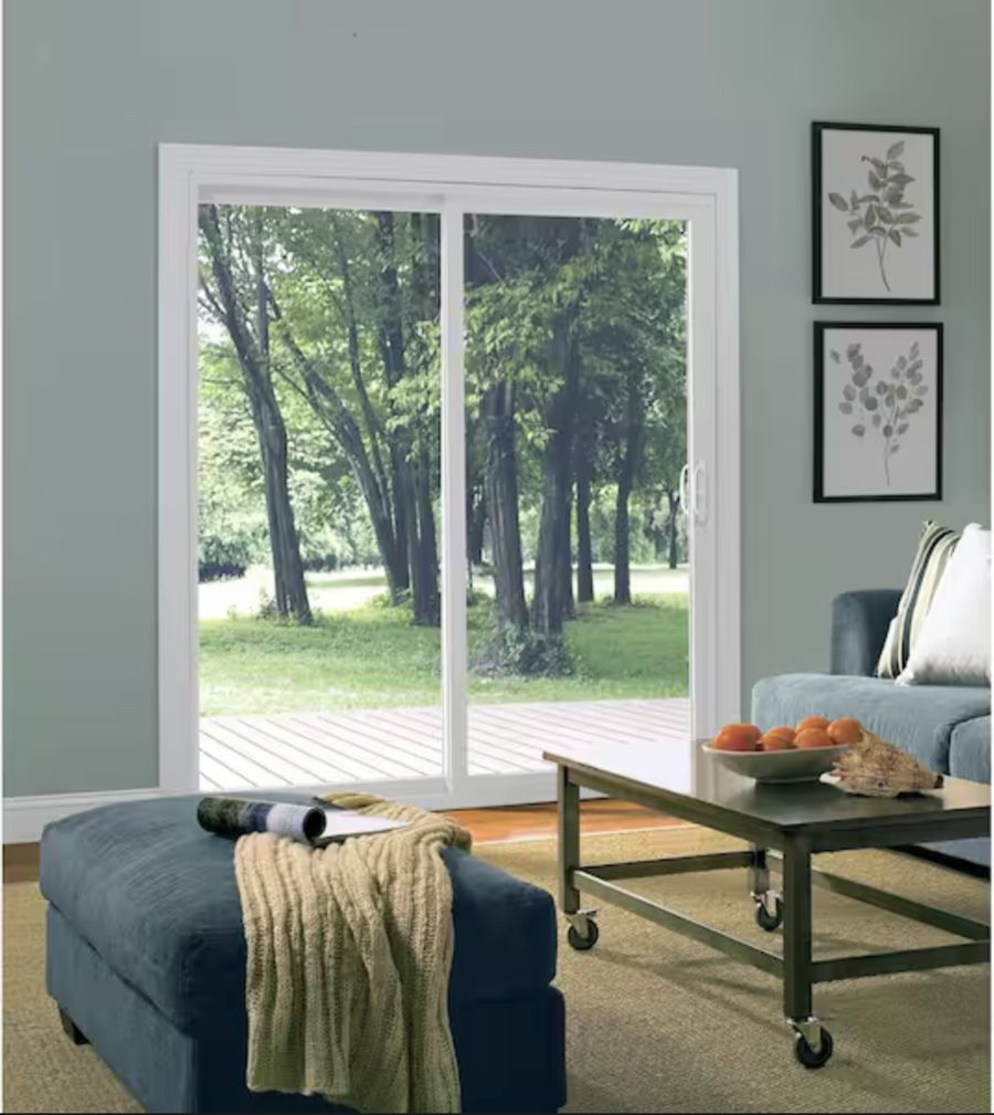 Sliding patio door with a view of a wooded backyard
